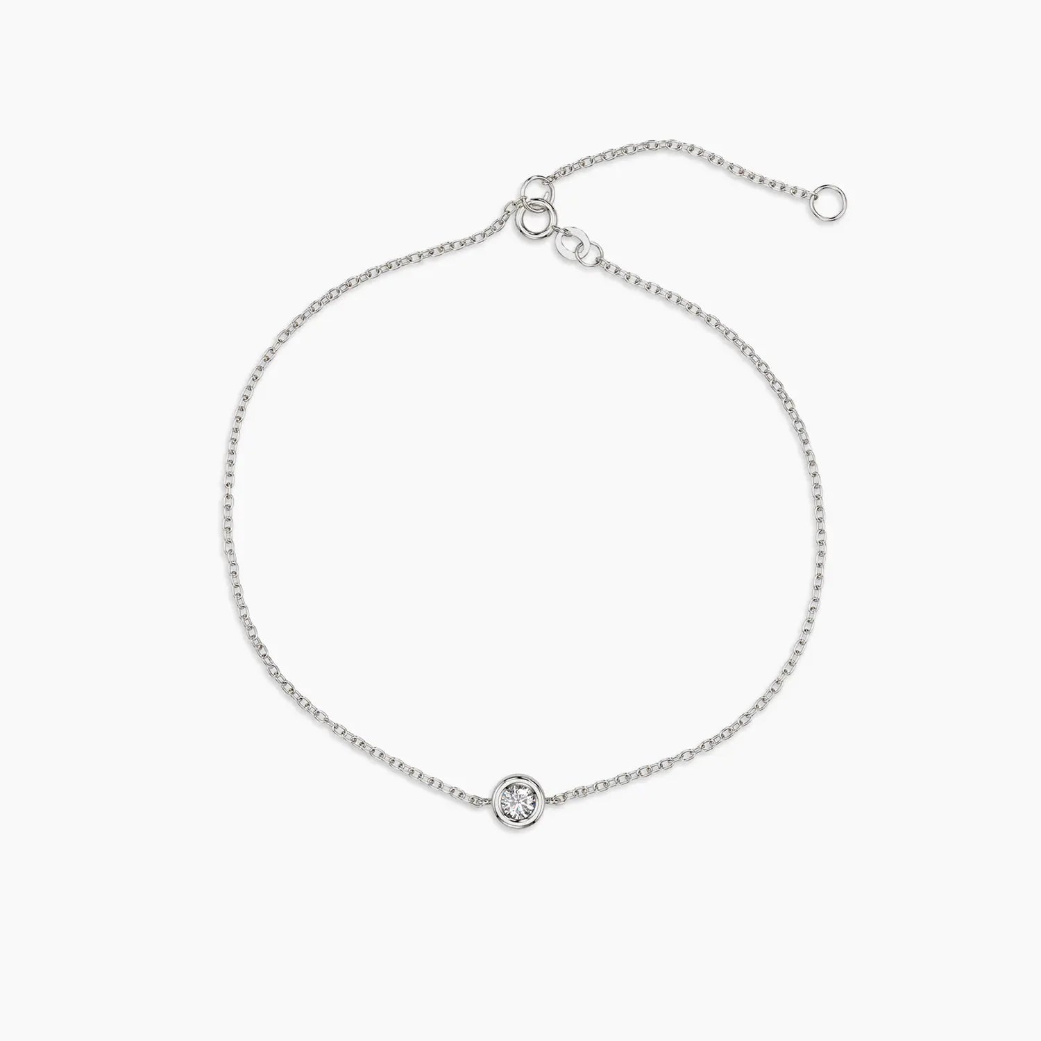 Classic white gold bracelet featuring a single bezel-set diamond, displayed on a white background with adjustable clasp.

