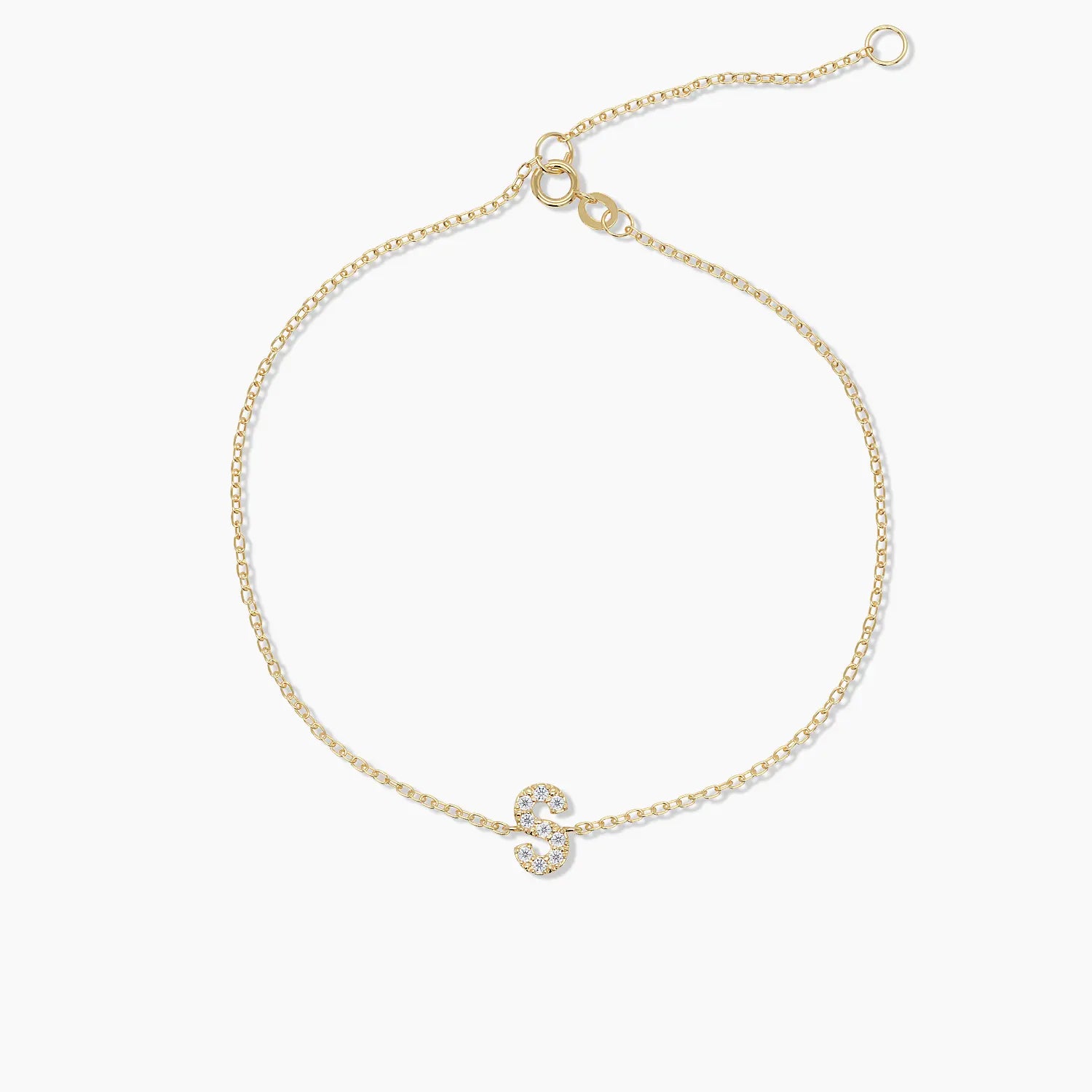 Solid gold bracelet with letter “S” charm in pavé diamonds, shown flat.