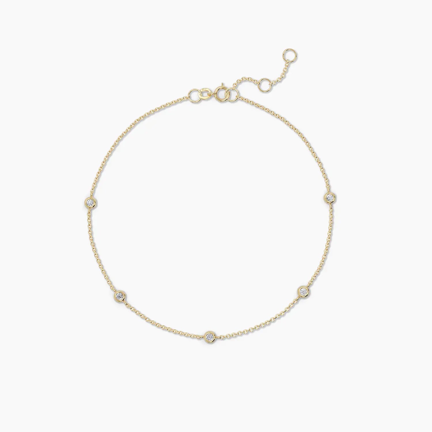 14k yellow gold bracelet with five bezel-set diamonds spaced evenly across a fine chain, styled flat against a clean background.

